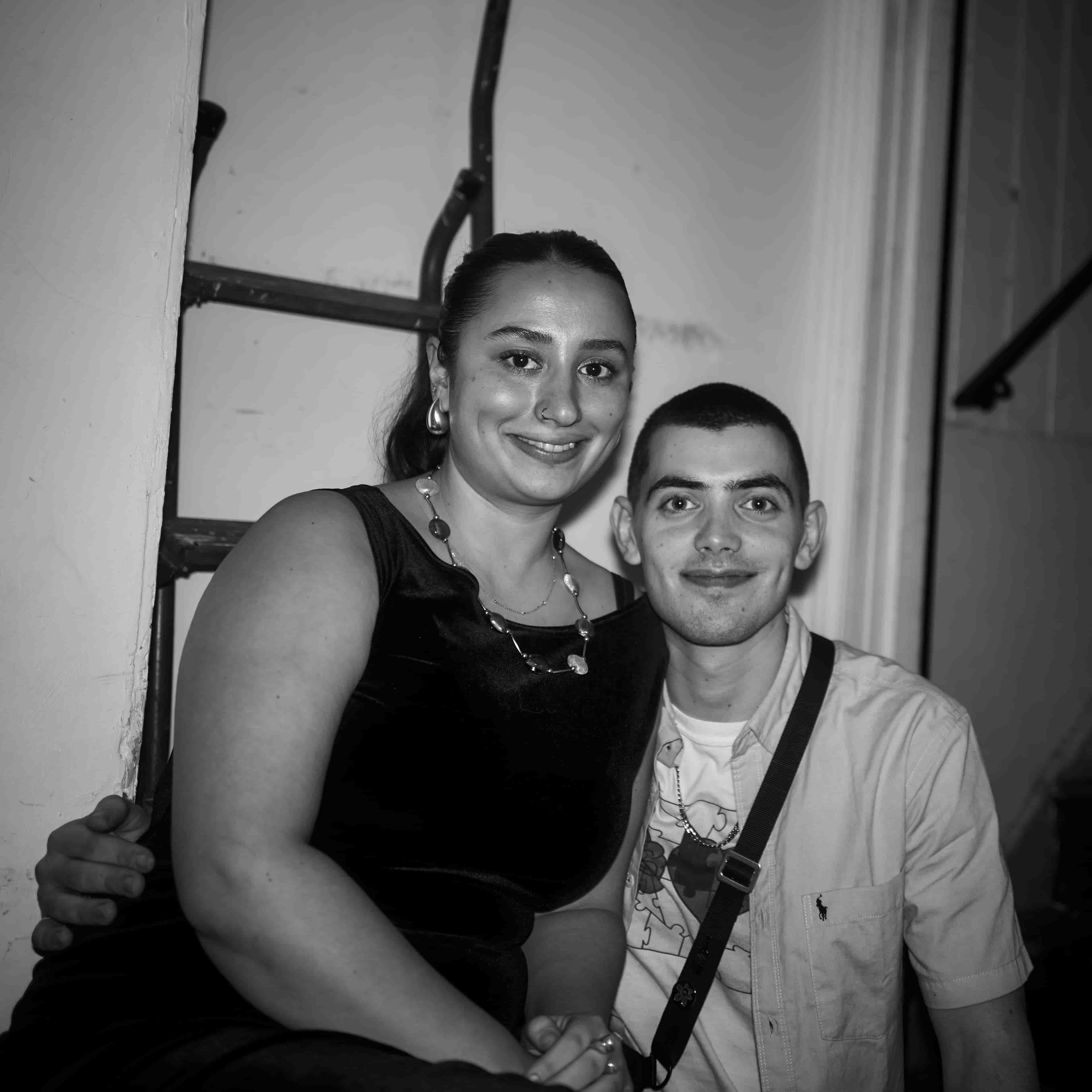 Party in the pub, two people posing for the camera with friendly smiles.
