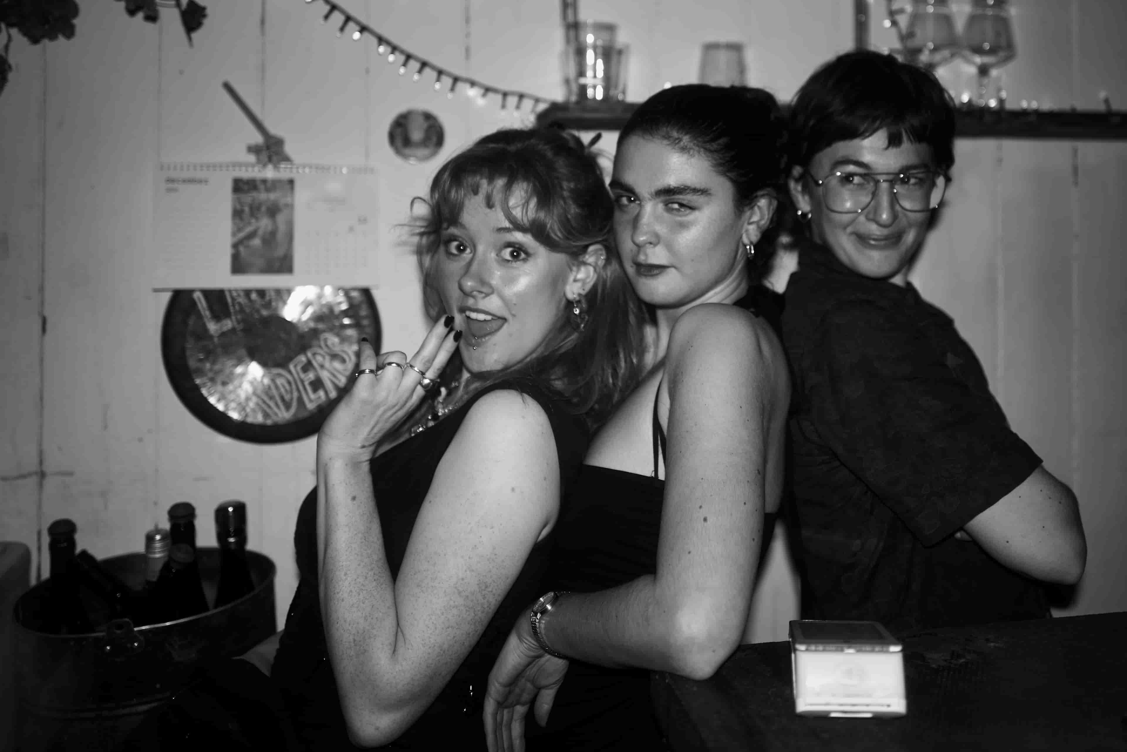 Party in the pub, three people posing for the camera.