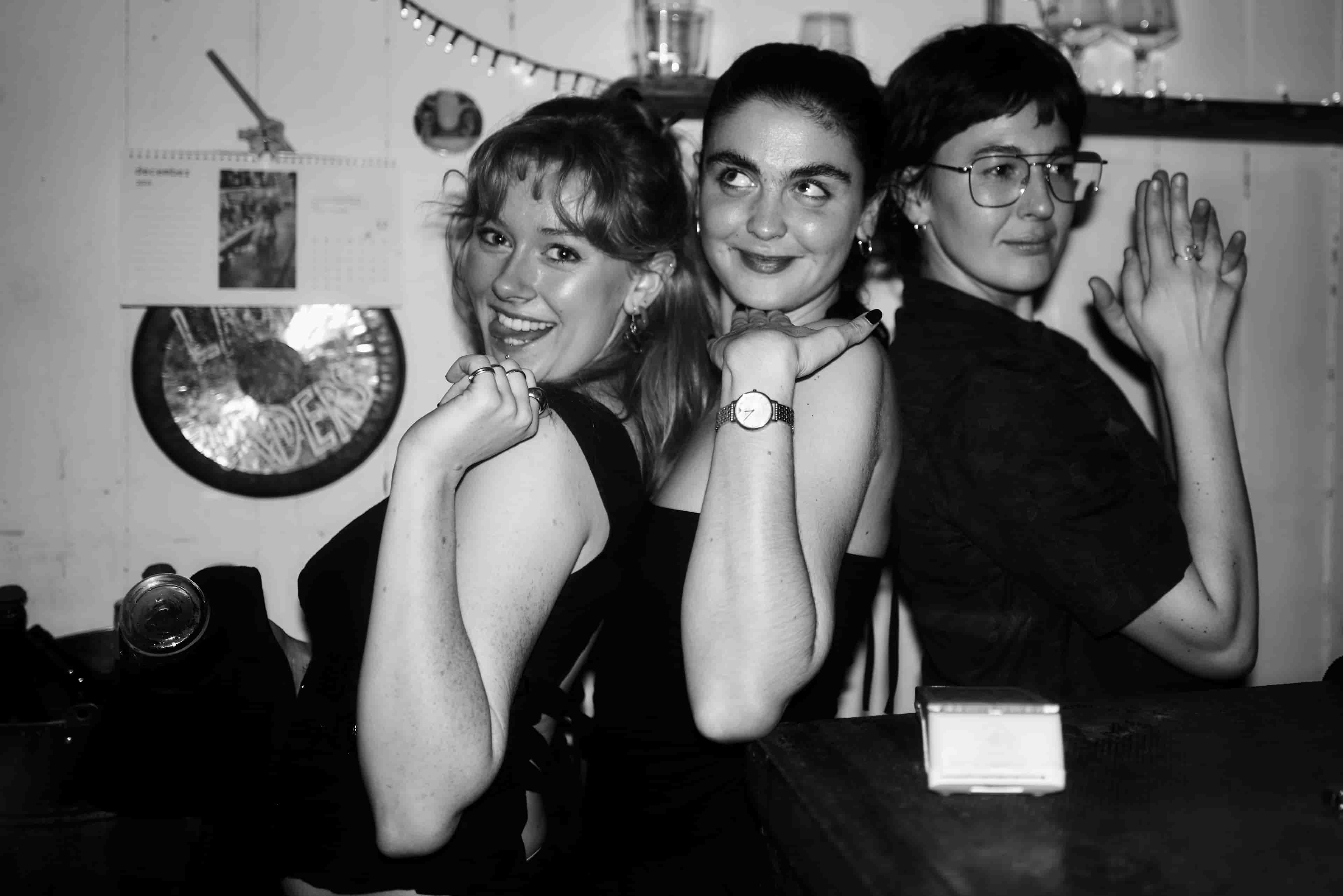 Party in the pub, same three people posing for the camera.