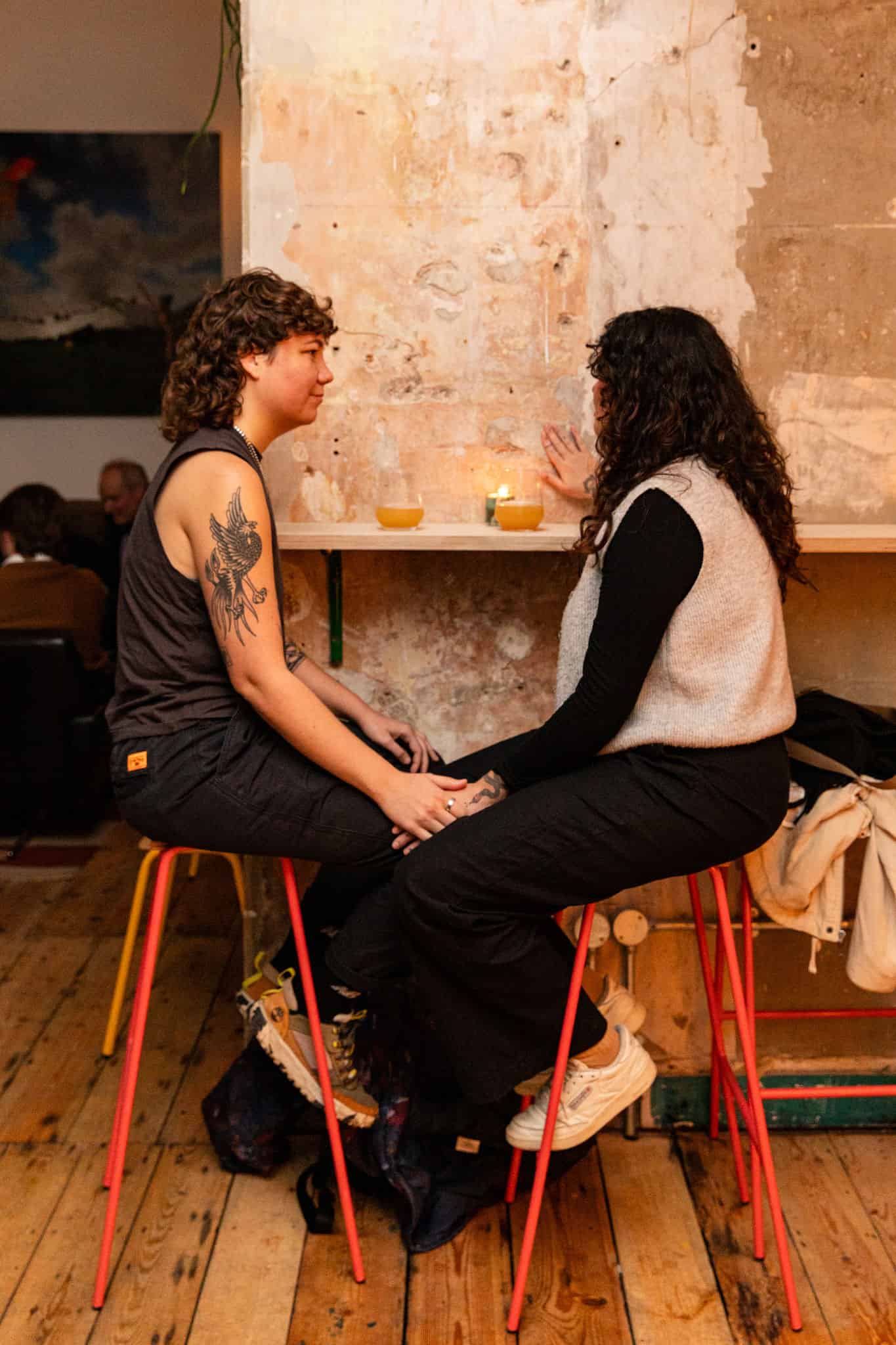 Two people talking at table by Ellen Richardson